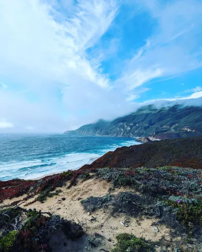 Big Sur coastline with fog rolling over the hills